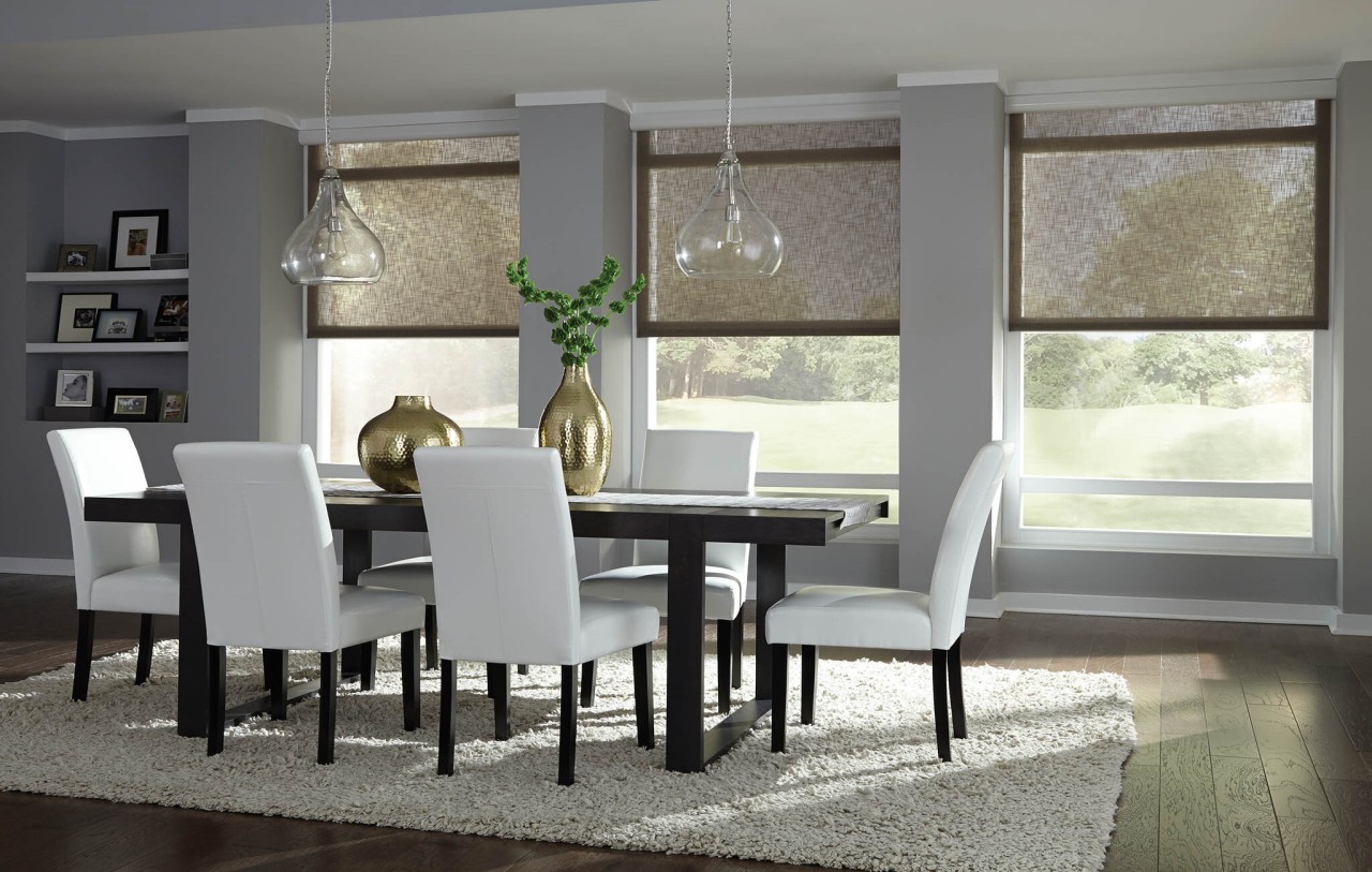 In a dining room, Lutron’s shades are halfway down, letting afternoon sun come through the window.