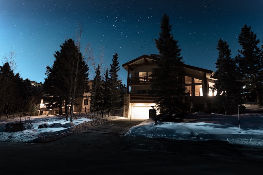  Outside view of a modern two-story home in the suburbs at night.